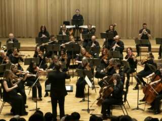 Liverpool Mozart Orchestra performing on stage at The Tung Auditorium