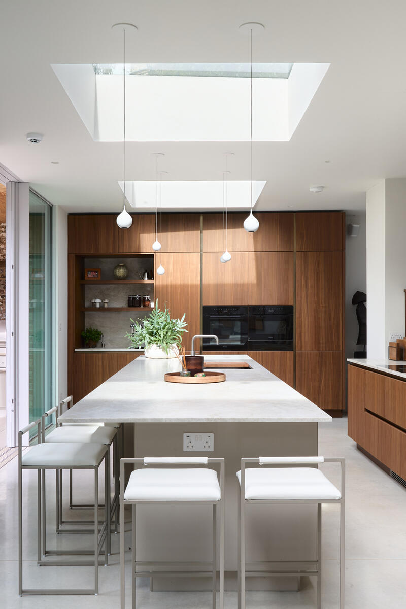 Modern Chiswick kitchen with skylights, island and wood cabinetry Short description: