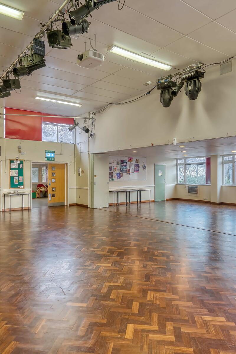 Brick-built community hall with flat roof and entrance canopy, set within its own car park and landscaped frontage, located near Pinewood Studios.