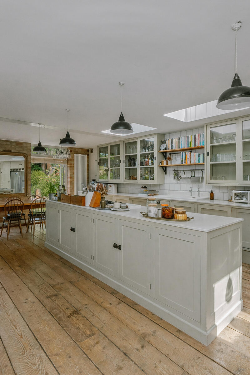 Large country kitchen with island, timber floors and garden views