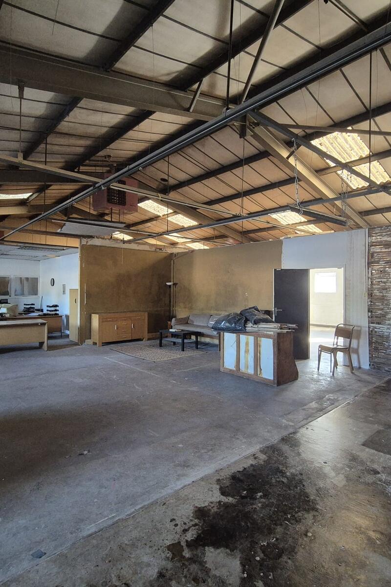 Upper-floor industrial space with exposed steel roof structure