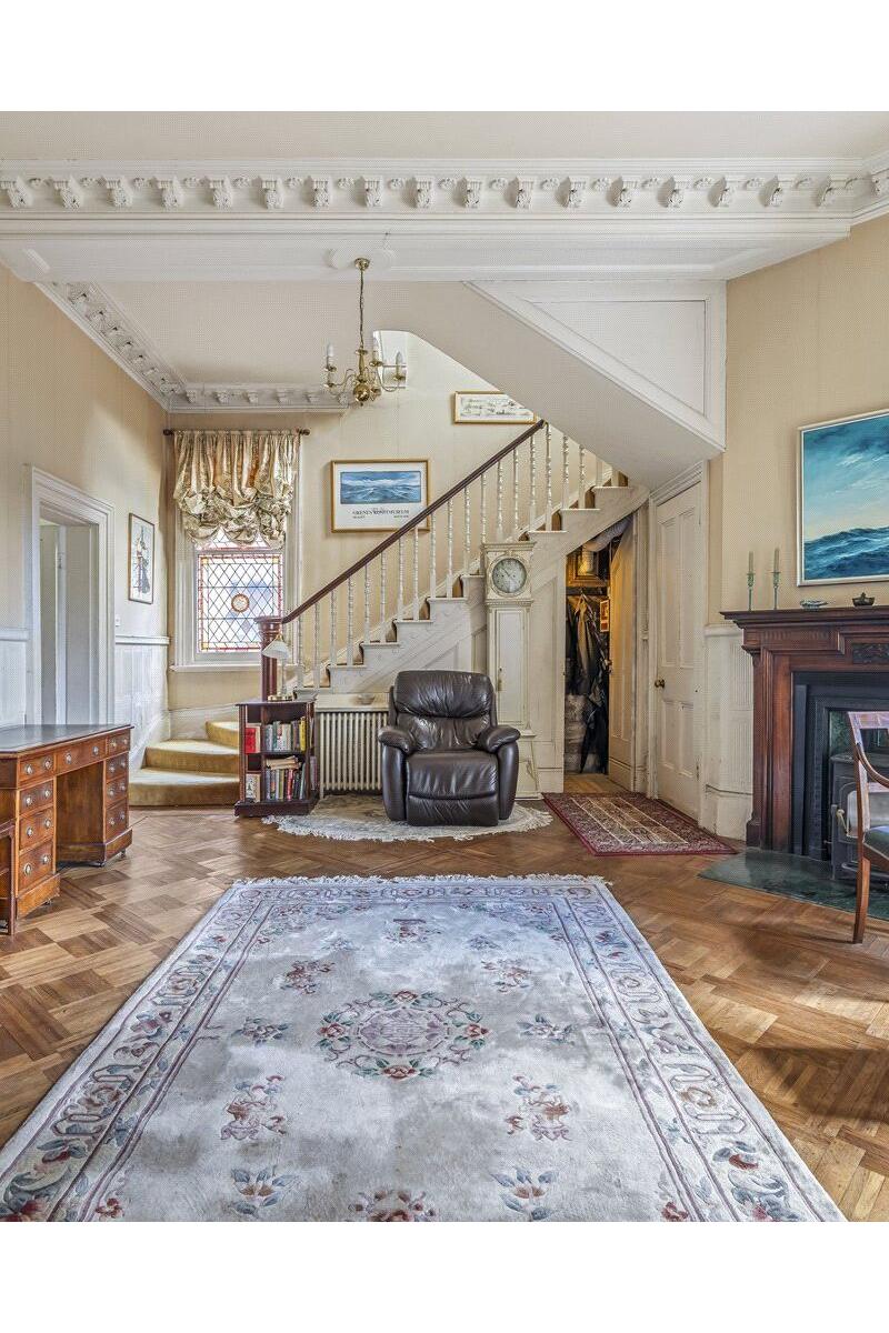 Georgian reception hall with staircase and original fireplace