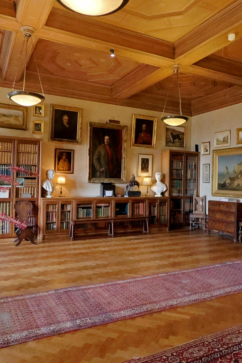 Elizabethan mansion entrance hall with timber ceiling and portrait gallery