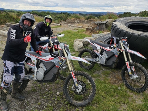 Motorcycle riders smiling for the camera enjoying a demo day on Stark Vark eBikes