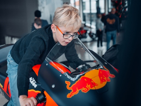 Young boy on a KTM race bike simulator