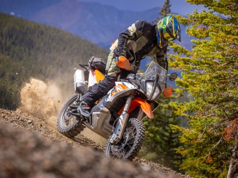 Motorcycle rider on an offroad trail in a mountain environment