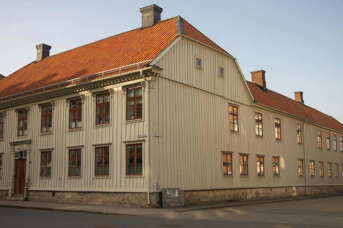 Charming historic wooden building with red roof in Jönköping, Sweden, during daytime.