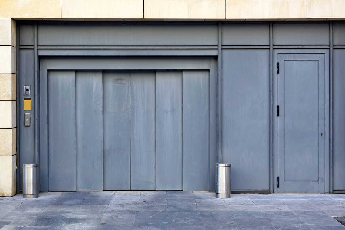 Garageport med integrerad ytterdörr i byggnadens fasad