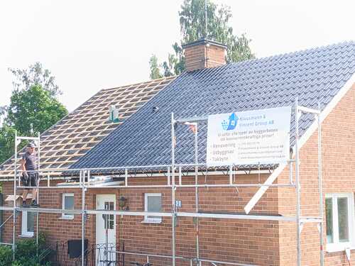 Takrenovering på villa med hantverkare och ställning