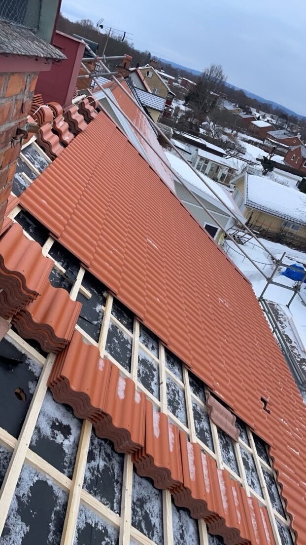 Röda tegelpannor, snötäckt tak – Sockenvägen i Borlänge, takbyte av Sol och Tak Dalarna