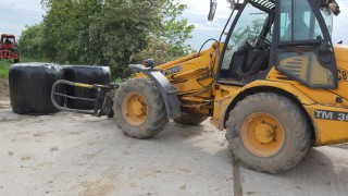 What is the correct way to stack round bales of silage?