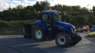 Livestock trailer carrying 12 cows overturns at roundabout