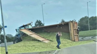 Overturned tractor trailer spills its contents all over the road