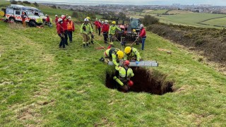Farmer rescued after falling down 60ft sinkhole in field
