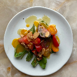 Meal card cover for: Tomatoes with miso-mango dressing and fried almonds
