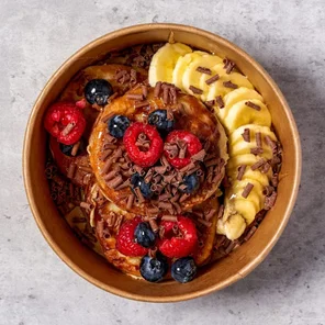 Meal card cover for: Protein Pancakes with Banana, Mixed Berries, Chocolate Curls & Honey 🍌🫐🍫🍯