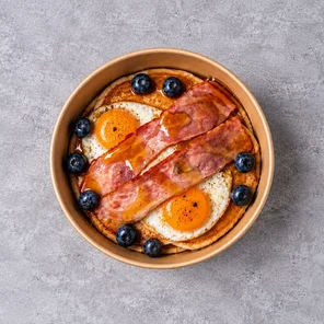 Meal card cover for: Protein Pancakes with Two Fried Eggs, Turkey Bacon, Blueberries & Maple Syrup.