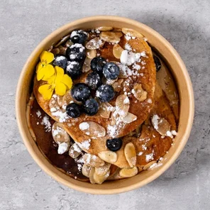Meal card cover for: Protein Pancakes with Blueberries, Flaked Almonds, Icing Sugar, Cinnamon & Maple Syrup.