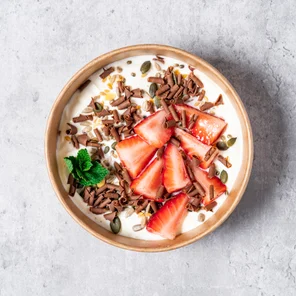 Meal card cover for: High protein Greek yogurt with strawberries, mixed seeds, chocolate curls and garnished with mint leaves.