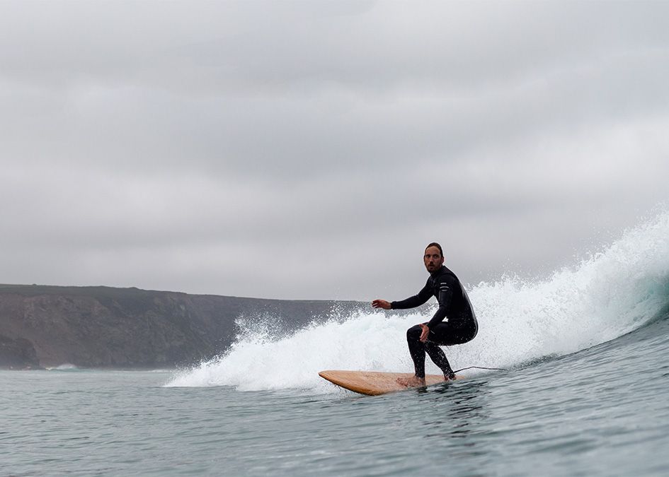otter surfing wave wooden surfboard
