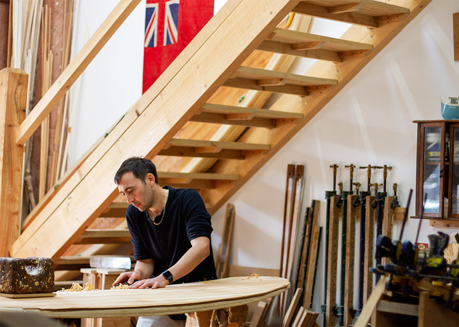 Otter wooden surfboard making workshop blue doors henry and matt portrait cornwall henry shaping