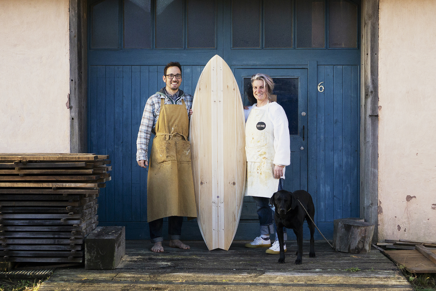 bodhi and James Otter buddy wooden surfboard workshop blue doors
