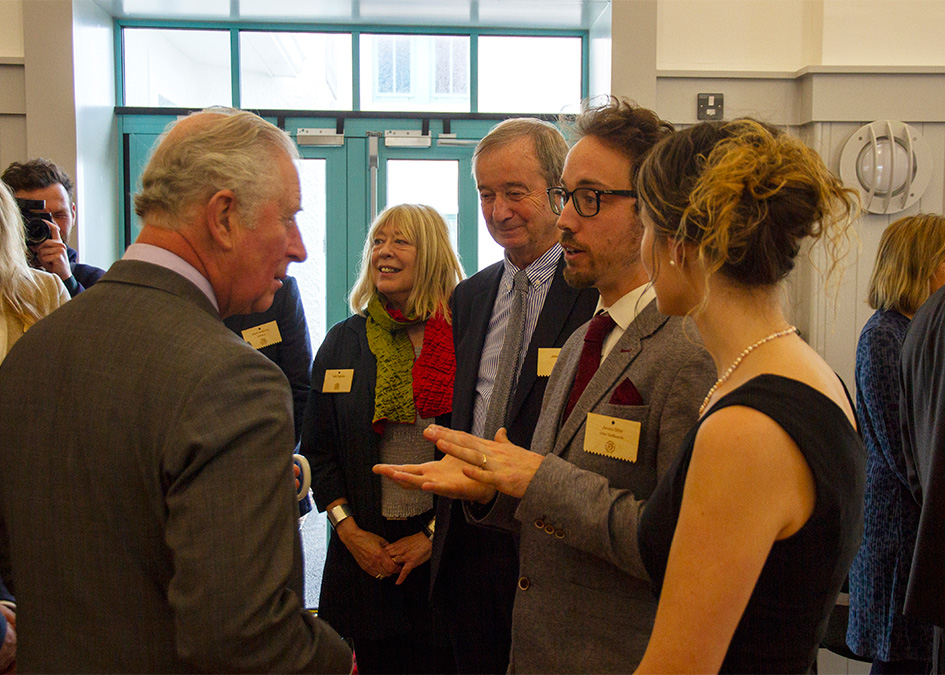 prince of wales prince charles duke of cornwall signs wooden surfboard to signify patronage for surfers against sewage hugo tagholm James Otter