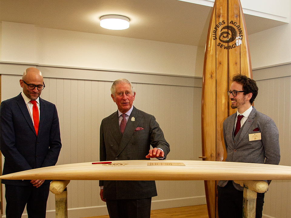 prince of wales prince charles duke of cornwall signs wooden surfboard to signify patronage for surfers against sewage hugo tagholm James Otter