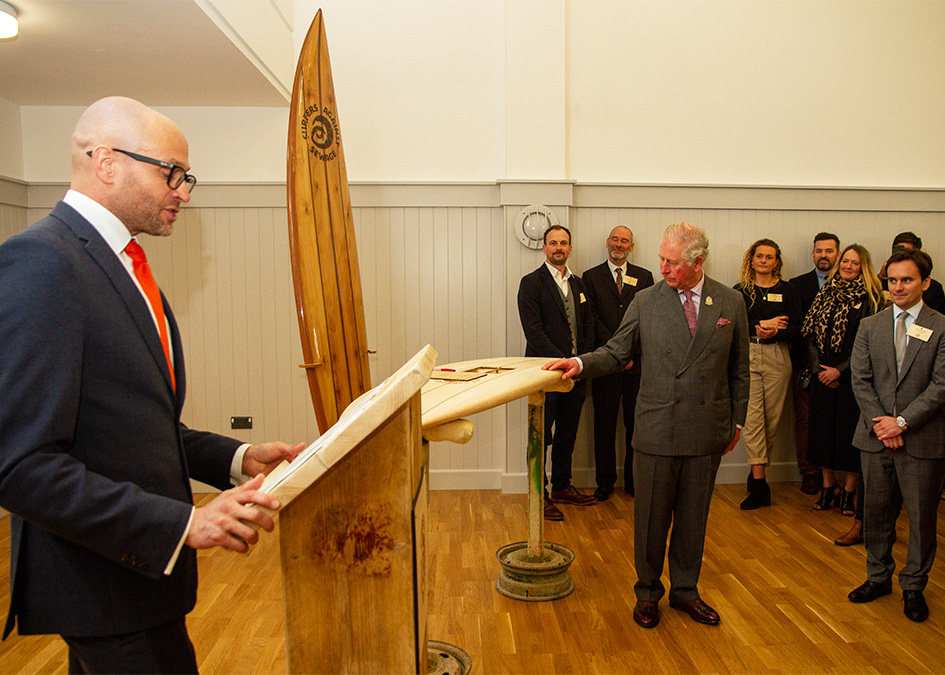 prince of wales prince charles duke of cornwall signs wooden surfboard to signify patronage for surfers against sewage hugo tagholm James Otter