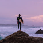 ADPT Film grab Alan Stokes x Otter Surfboards wooden surfboard Alan on the rocks