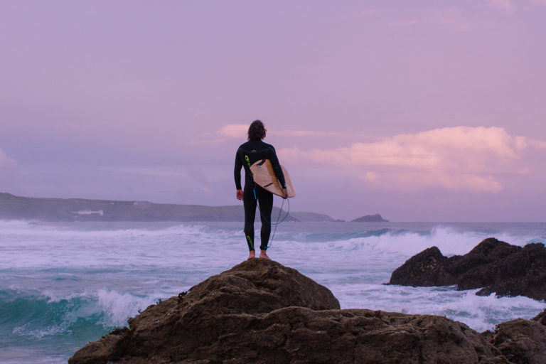 ADPT Film grab Alan Stokes x Otter Surfboards wooden surfboard Alan on the rocks