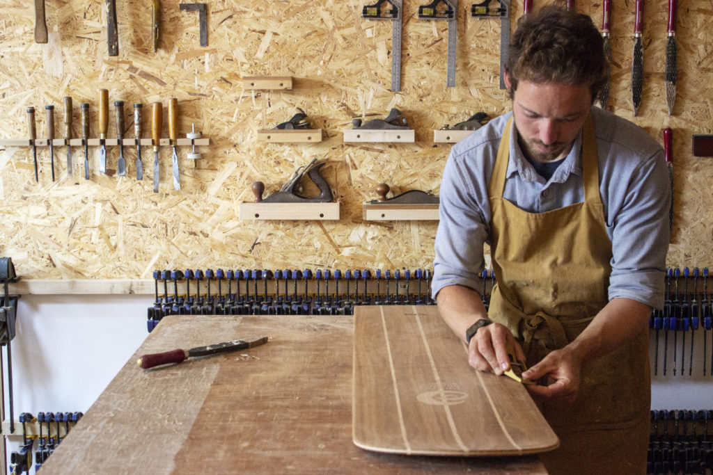 James Otter shaping a bellyboard for HRH Prince Charles, the prince of wales, the duck of cornwall for surfers against sewage with oak wood from highgrove house
