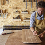 James Otter shaping a bellyboard for HRH Prince Charles, the prince of wales, the duck of cornwall for surfers against sewage with oak wood from highgrove house