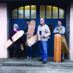 Wooden bellyboard group stood outside the otter surfboards workshop with James