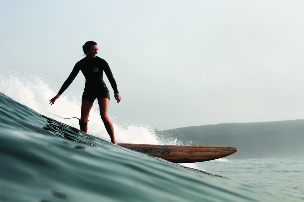 Rebecca Pepperell Surfing the Otter Surfboards Seasaw wooden longboard at Perranporth in Cornwall