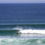 James Otter classic lines at Gwithian in the summer on his wooden surfboard Wicket in St Ives Bay