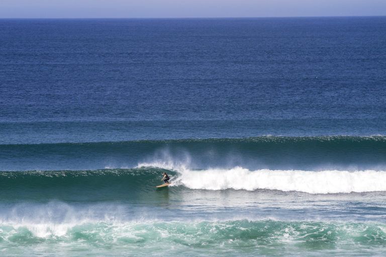 James Otter classic lines at Gwithian in the summer on his wooden surfboard Wicket in St Ives Bay