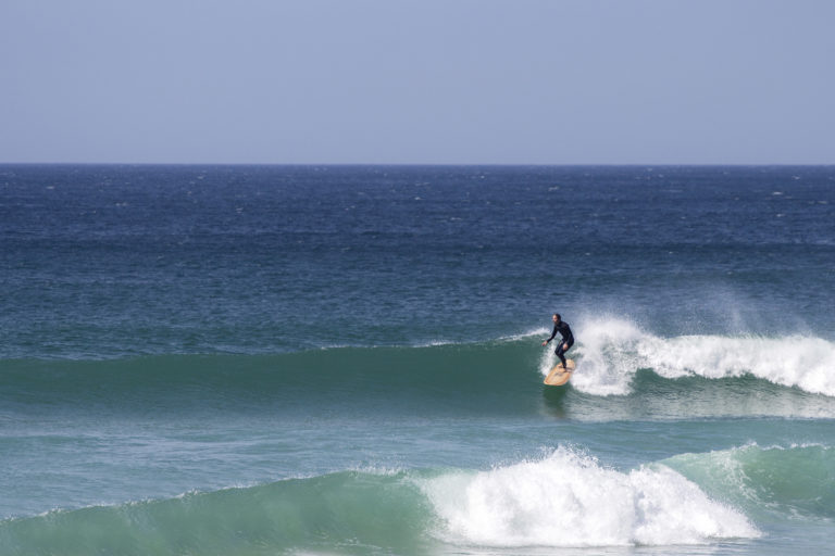 James Otter on his Wicket Wooden surfboard surfing in Cornwall