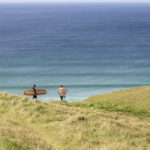 James Otter and Tom with wooden surfboards on the coast in Cornwall Wicket and Coaster
