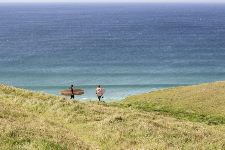 James Otter and Tom with wooden surfboards on the coast in Cornwall Wicket and Coaster