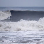 Johnny Leon surfing a big wave at Milook on an Otter Wooden Clipper surfboard in Cornwall. Surfer surfing wave