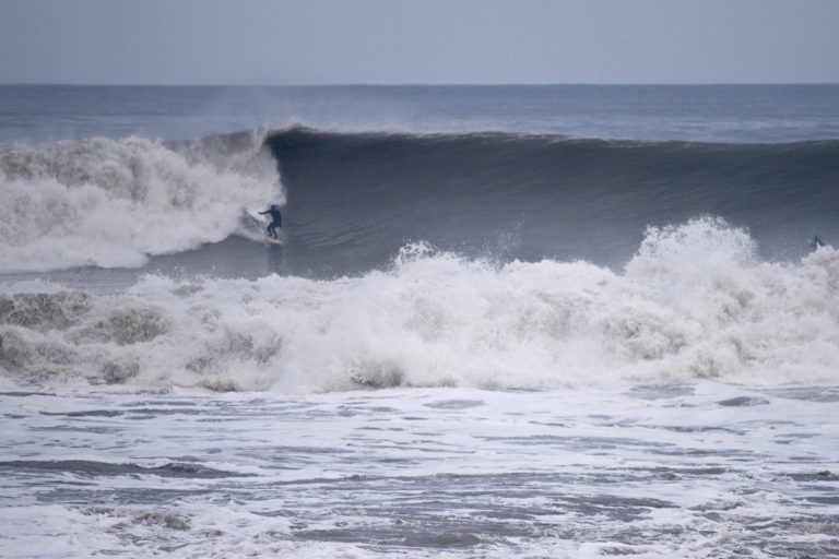 Johnny Leon surfing a big wave at Milook on an Otter Wooden Clipper surfboard in Cornwall. Surfer surfing wave
