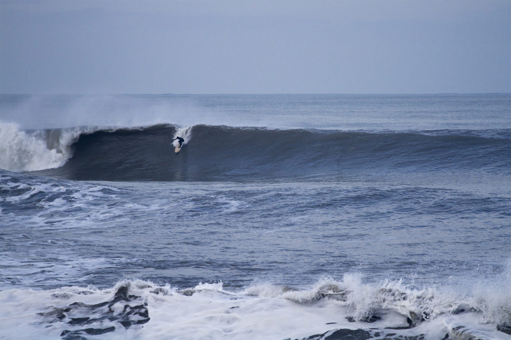 Johnny Leon Dropping into a big wave at Milook on an Otter Wooden Clipper surfboard in Cornwall. Surfer surfing wave