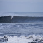 Johnny Leon Dropping into a big wave at Milook on an Otter Wooden Clipper surfboard in Cornwall. Surfer surfing wave