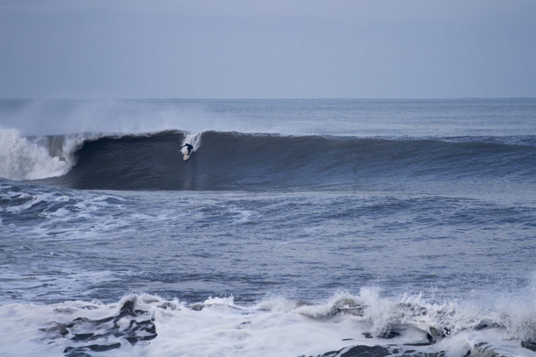 Johnny Leon Dropping into a big wave at Milook on an Otter Wooden Clipper surfboard in Cornwall. Surfer surfing wave