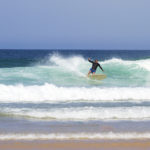 Dan Crockett leans into a turn at Gwithian in the summer in Cornwall on his Clipper Otter Wooden surfboard.