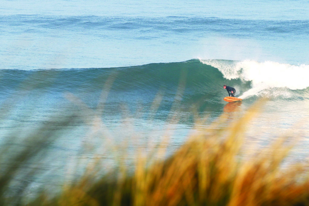 Gideon bottom turns his Otter wooden surfboard at Gwithian. Island Hopper