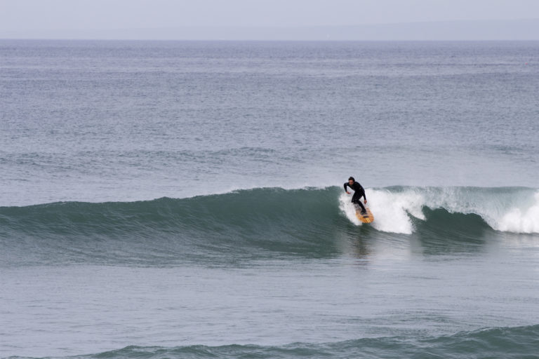 Chris lines up a fun wave at Church Cove, in Cornwall on his Jetty Otter Wooden surfboard.