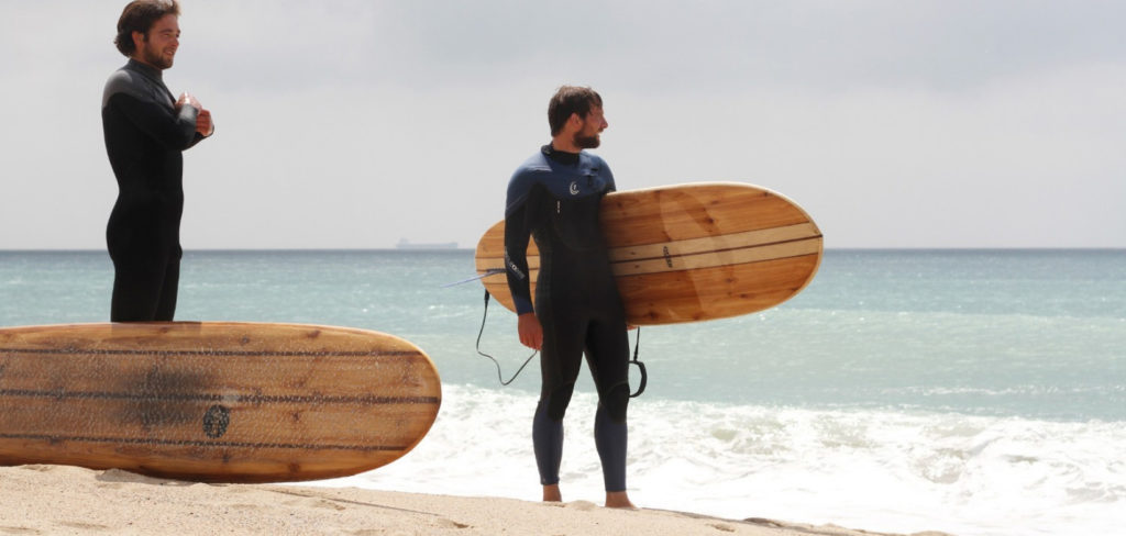 Tony and Chris on the beach at Praa Sands with wooden longboards, Otter surfboards wicket and Seasaw.