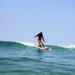 Sarah finding a wave on the otter surfboards Wood Burner Wooden surfboard at Chapel Porth, Cornwall Super stylish